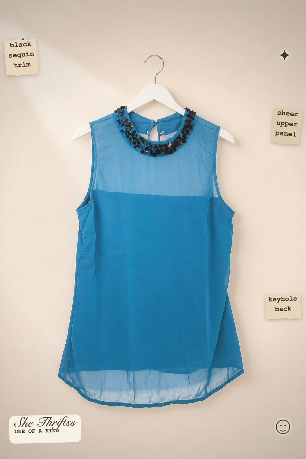 Blue embellished sleeveless blouse